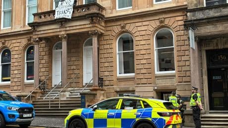 Police seal off city centre building amid balcony protest