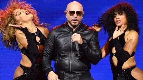 Inside Pitbull mania as Mr Worldwide convinces 20,000 fans to wear bald caps and suits