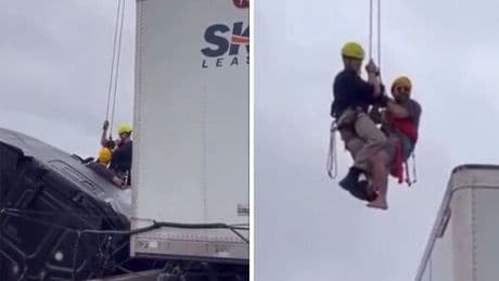 Dramatic moment firefighter rescues trapped driver from truck dangling over bridge