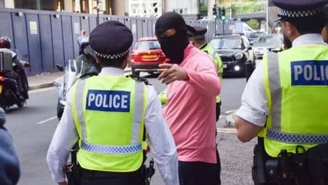 Three arrested at asylum hotel protest 'with kids present' as officer punched