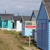 Beach hut owners at war with 'greedy' council after rent rockets by £200 despite being flooded HALF the year, the sea being too dirty to swim in... and a seawall blocking their view