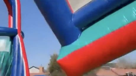 Terrifying moment bouncy castle takes off in freak wind flying 40ft into air sending children plunging back to earth