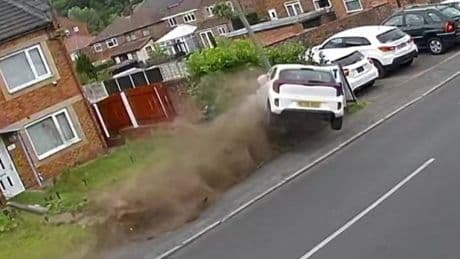 Driver crashes and flips vehicle onto residential street narrowly missing homes