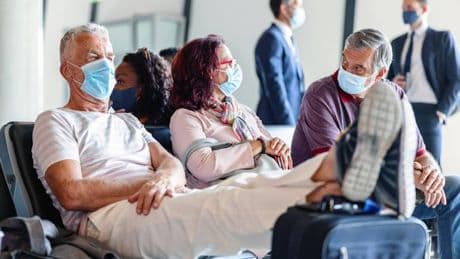 WHO warns of 'more infectious' Covid variant as travellers urged to mask up and get jags