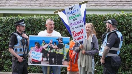 Small band of protestors greet Trump at Turnberry as President lands in Scotland