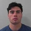 Footballer who killed fellow non-league player in 'cowardly' one-punch attack at railway station is jailed for nearly seven years