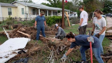 Armies of Texas volunteers dig out, clean up, after fatal floods