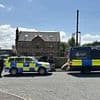 'Army' of police shut down crime boss 'Hotdog' Smith's house on illegal scrapyard as wife says she will be forced to live 'in a TENT'
