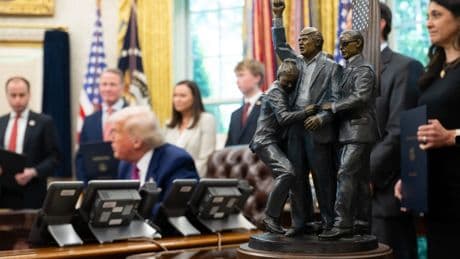 Trump adds a new piece of art to the Oval Office - a statue of himself moments after the assassination attempt in Butler