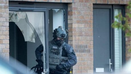 Six men charged after gang war cops storm houses in dawn raids as feud escalates