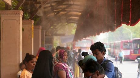 In one Indian city, reflective paint and bus stop sprinklers offer relief from killer heat