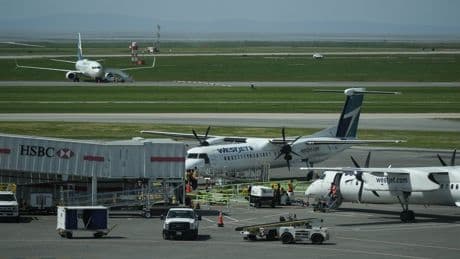 WestJet passengers evacuate on slides after engine fire at Vancouver airport
