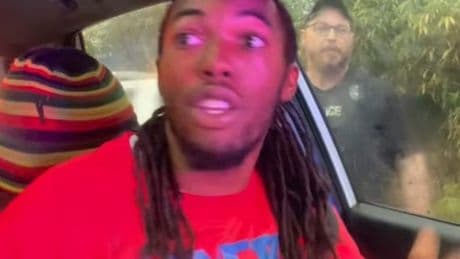 Officer smashes car window then punches driver stopped for not having headlights on