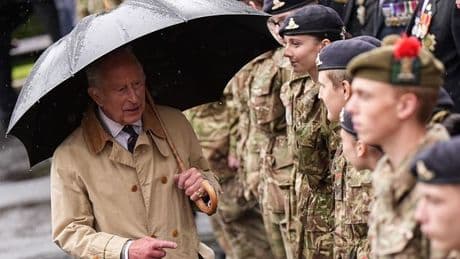 King Charles rushes to console teenager who passes out during rain-soaked visit