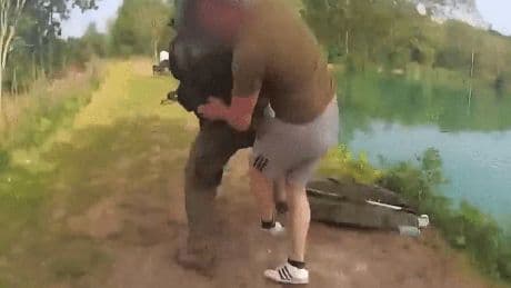Shocking moment fishermen dad and his topless son scrap with officials after they were caught angling without licence