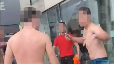 Moment bare-chested men fight in shopping centre as brawl breaks out