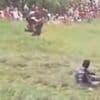Moment daredevil somersaults down cheese-rolling hill - as organisers call in RUGBY PLAYERS to stop flying participants after council banned tradition over safety fears