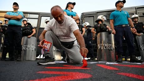Riot police block protesters from approaching Israeli cruise ship in Greece