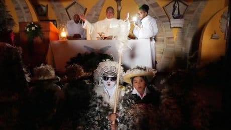 Despite rainy weather, Catholics in a Paraguayan town dress as birds to honor their patron saint