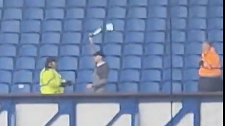 Celtic fan invades Rangers end as rogue punter huckled by stewards after breaking cover and waving scarf