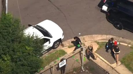 Shock footage shows bleeding victim calling for help after gunman opens fire feet from a high school killing one