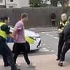 Moment thug punches female officer in the face before she bravely brushes off the attack and pins him to the ground