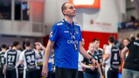 Handball-Schiedsrichter blättern im Regelheft in einem wilden Spiel