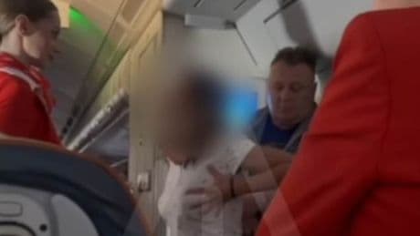 Cabin crew calls on passengers to subdue air rage woman demanding upgrade