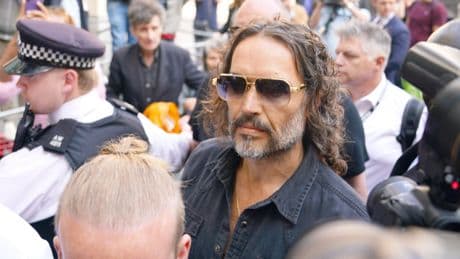 Comedian and actor Russell Brand arrives at court after being charged with rape and sexual assault