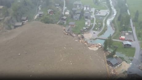 Swiss town BURIED after horror avalanche thunders down mountain in huge landslide & submerges homes & causes evacuation