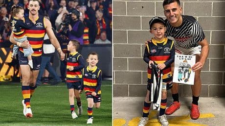 Footy fans go wild as star's son steals the show at his dad's 300th match by going crazy over a rival player in heartwarming scenes