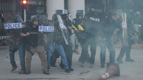Trump’s riot squad throws flash grenades at protesters outside immigration raid