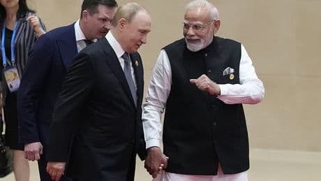 Putin and Modi walk hand-in-hand into China's anti-NATO summit: Russian tyrant beams as he is warmly welcomed at Xi's talks aimed at establishing a new world order