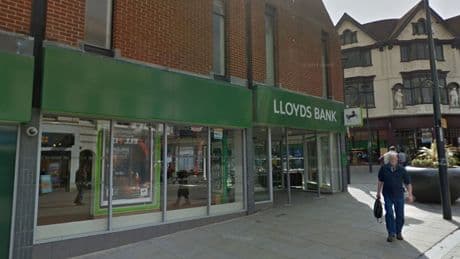 Customer stabbed to death inside bank - as two men arrested