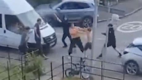 Brutal fight erupts as machete thugs hack each other before Mini Cooper mows man down