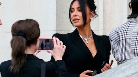 Kim Kardashian dripping in diamonds and flanked by armed cops as she arrives for Paris robbery trial