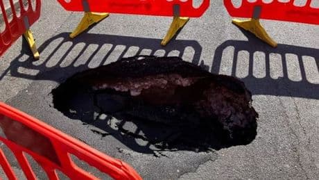 Huge sinkhole opens up and forces road closure with locals shocked
