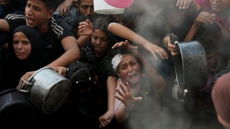 Desperate children and adults in Gaza struggle to get food as Israel blocks aid