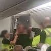 Shocking moment 'drunk' passenger is arrested 'after punching air hostess and shouting "the plane is going to crash"' in front of screaming cabin crew
