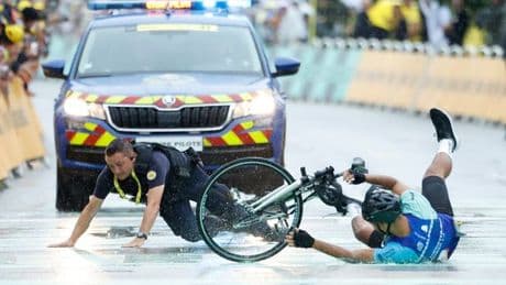 Tour de France prankster knocked off bike by police in chaotic scenes