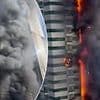 Dramatic moment huge inferno rips through 67-storey Dubai skyscraper with 4,000 residents as debris falls from the sky