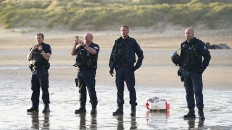 Shameful pic of French cops watching migrants sail to Britain proves we’ve got to take action to stop small boats