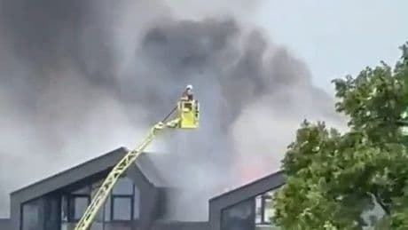 Huge fire at block of flats in east London with woman and baby treated at scene