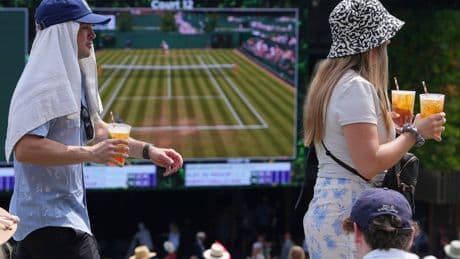 Photos of Wimbledon fans and players struggling to stay cool in record-breaking heat