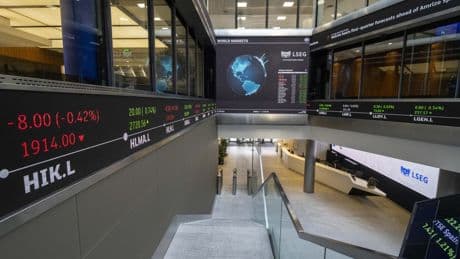 FTSE 100 closes higher after survey shows UK services sector returned to growth