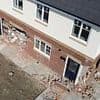 JCB rampage leaves newbuild estate in ruins after 'teen yob' smashes through SEVEN homes