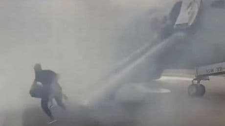 Horror moment American Airlines plane bursts into flames as passengers flee