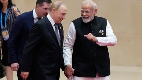 Putin and Modi hold hands as leaders gather for China summit