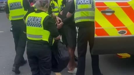 Police arrest man on street for 'feeding birds'