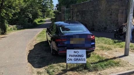 Brazen Audi driver sparks fury after mounting grass and 'ignoring parking sign'